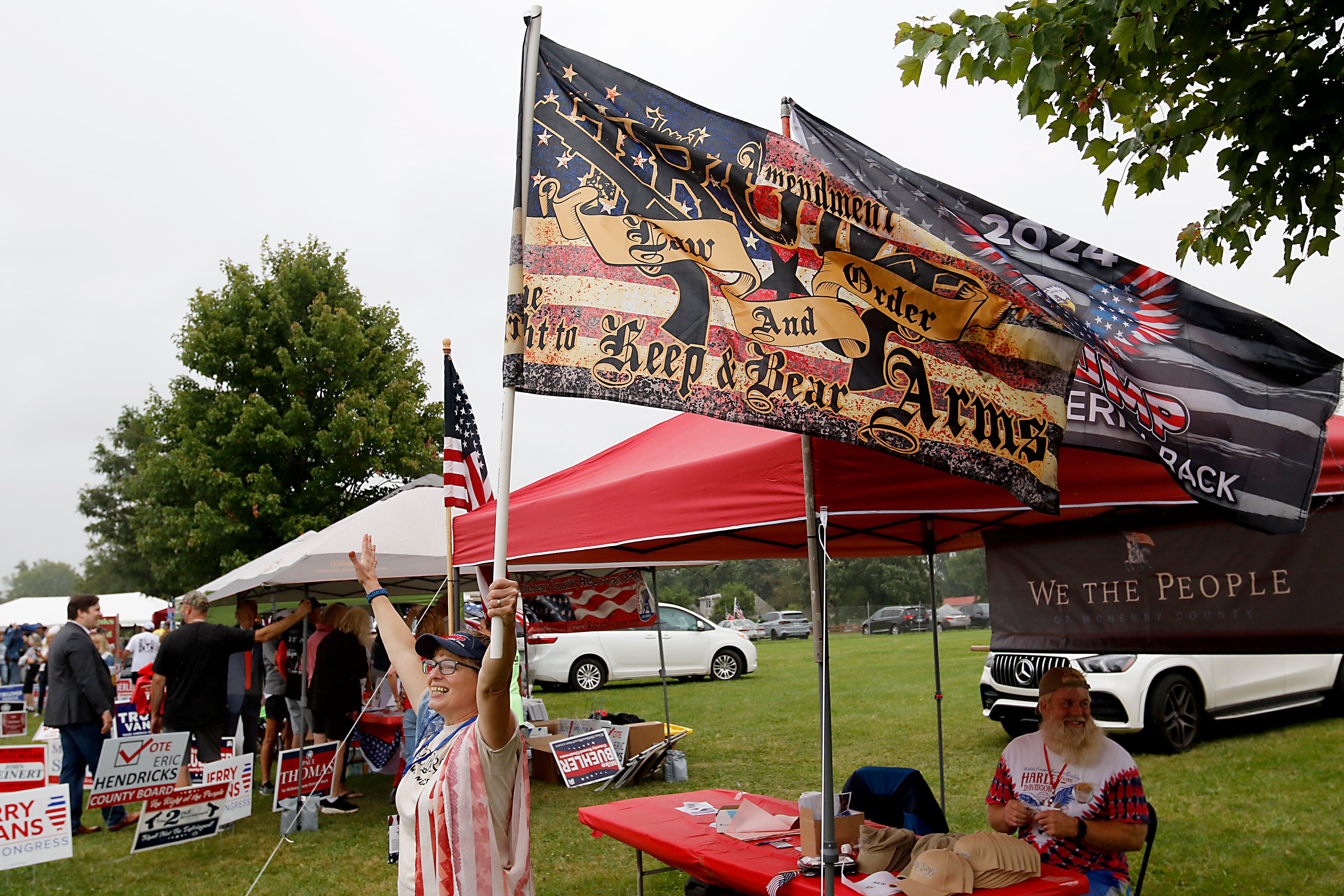 Rachel Johnson of Crystal Lake and from We the People McHenry County waves a flag during the Trump Now-Save the American Dream Rally at the McHenry County Fairgrounds on Sunday Aug. 18, 2024, in Woodstock.