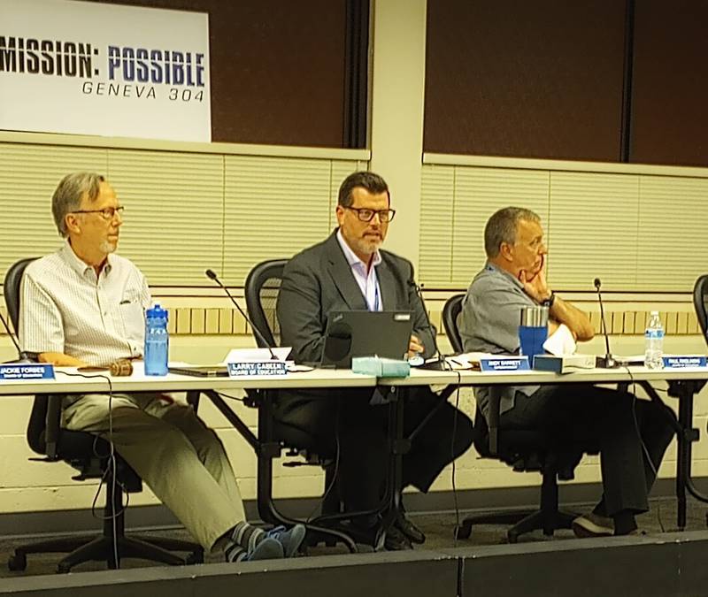 Geneva District 304 Superintendent Andrew Barrett (center) discusses a demographic report about the district's declining enrollment at the Sept. 9, 2024 school board meeting. Board President Larry Cabeen (left) and Board member Paul Radlinsky (right) also heard about a new development might bring more students into the district.