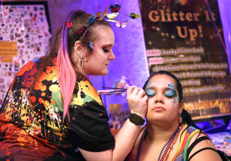 Kyla Jamar, from DeKalb, gets made up by Felicia Hendricks, owner of Paint Time Fun Face Painting, Thursday, June 20, 2024, during DeKalb Pride Fest at the Egyptian Theatre.