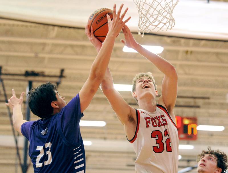 Yorkville's Jason Jakstys (32) goes up for a shot against Plano defender Isaiah Martinez (23) during a varsity basketball game at Yorkville High School on Tuesday, Dec. 19, 2023.