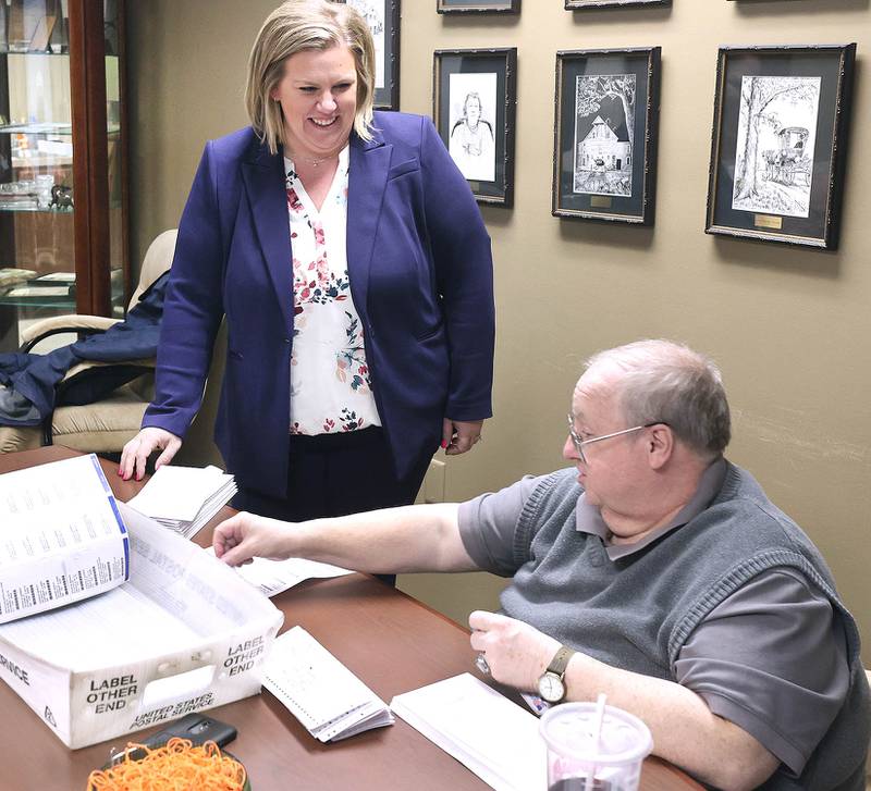 DeKalb County Clerk Tasha Sims visits with election judges Terry Heiland (left) and Steve Nemeth as they put vote-by-mail ballots in envelopes Wednesday, Feb. 22, 2023, in the DeKalb County Administration Building in Sycamore.