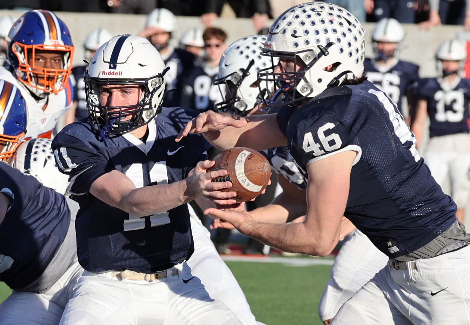 Cary-Grove's Peyton Seaburg hands the ball off to Logan Abrams Saturday, Nov. 25, 2023, during their IHSA Class 6A state championship game against East St. Louis in Hancock Stadium at Illinois State University in Normal.