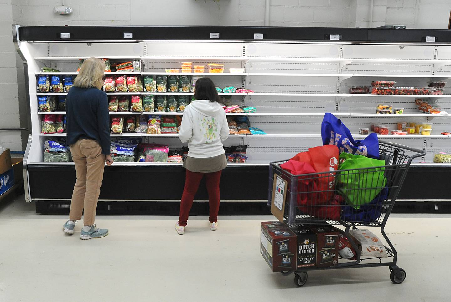 Volunteer Cynthia Bissell helps people shop for food Monday, April 25, 2022, at the Crystal Lake Food Pantry, 42 East Street, in Crystal Lake. Food pantries across McHenry County are combating both inflation and increasing need.