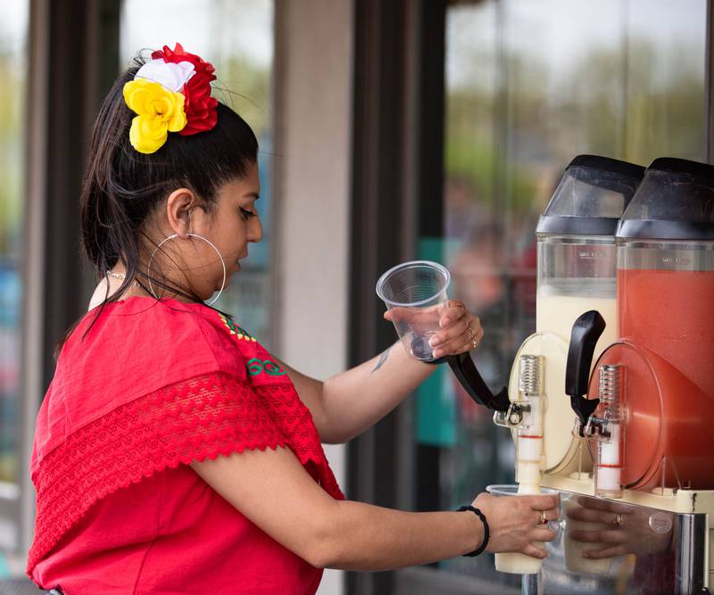 El Jimador Mexican Grill Co-owner Olivia Pacheco pours margaritas during Dekalb’s first Cinco de Mayo celebration co-hosted by Willrett Flower Co. at 3rd street in Dekalb on Friday, May 5, 2023.