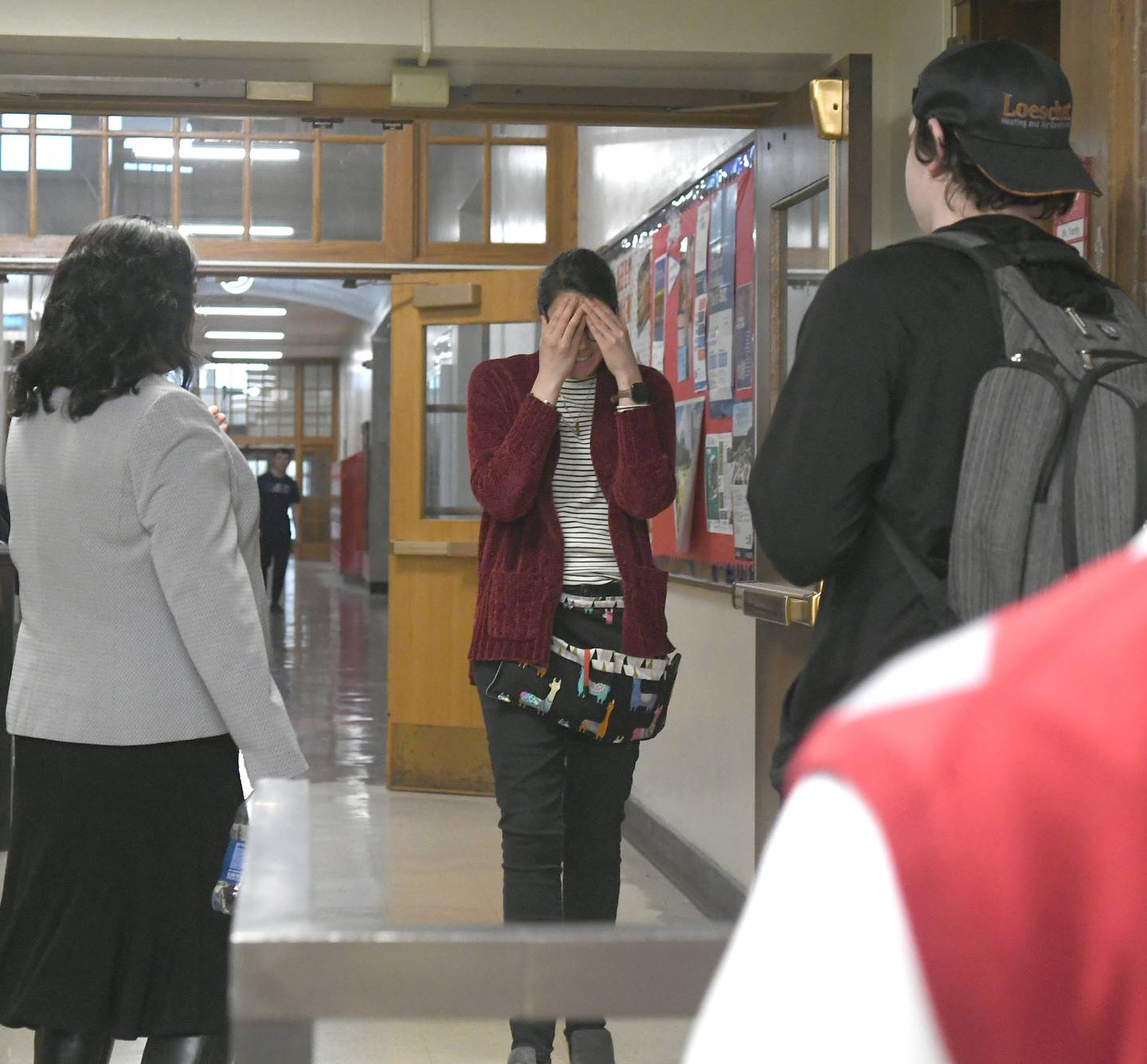 Oregon High School teacher Kimberly Radostits reacts by covering her face with her hands as she unexpectedly meets State Superintendent of Education Dr. Carmen I. Ayala before learning she had been chosen 2022 Illinois Teacher of the Year.