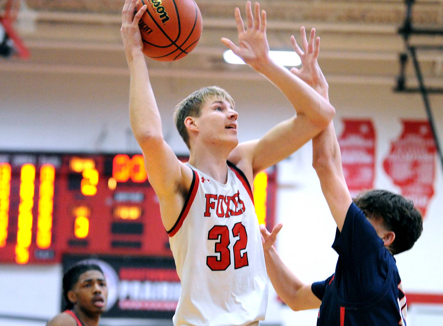 Yorkville's Jason Jakstys (32) puts a shot up over West Aurora defender Gabriel Gonzales during a class 4A regional semifinal basketball game at Yorkville High School on Wednesday, Feb. 21, 2024.