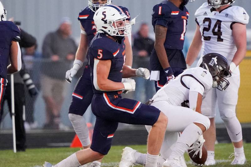 Oswego’s Carson Cooney (5) reacts after tackling Joliet Catholic's Nate Magrini (right) during a football game at Oswego High School on Friday, Sep 6, 2024.