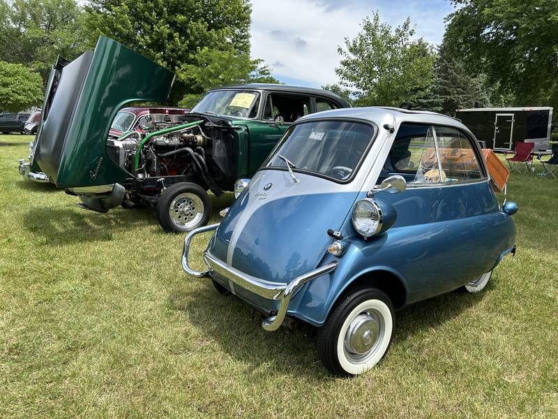 A record 137 cars took part in the Lyndon Car Show on Sunday, June 2, 2024. Here, a 1958 BMW Isetta 300, owned by Vicky and Jim Cope of Orion, sits next to a modified 1955 Plymouth Belvedere, owned by Jerry Tripp of Morrison.
