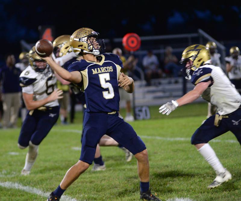 Polo's Gus Mumford has his eyes on a receiver as he drops back to pass during 8-man football action against Hiawatha on Friday, Sept. 13. 2024.