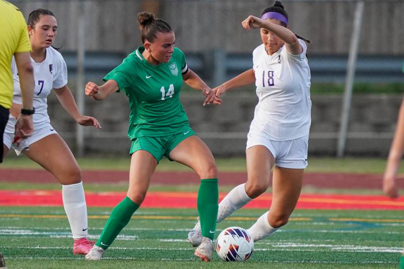 York’s Michaela Quinn (14) challenges Downers Grove North's Campbell Thulin (18) for the ball during a Class 3A Hinsdale Central Sectional semifinal soccer match at Hinsdale Central High School in Hinsdale on Tuesday, May 21, 2024.