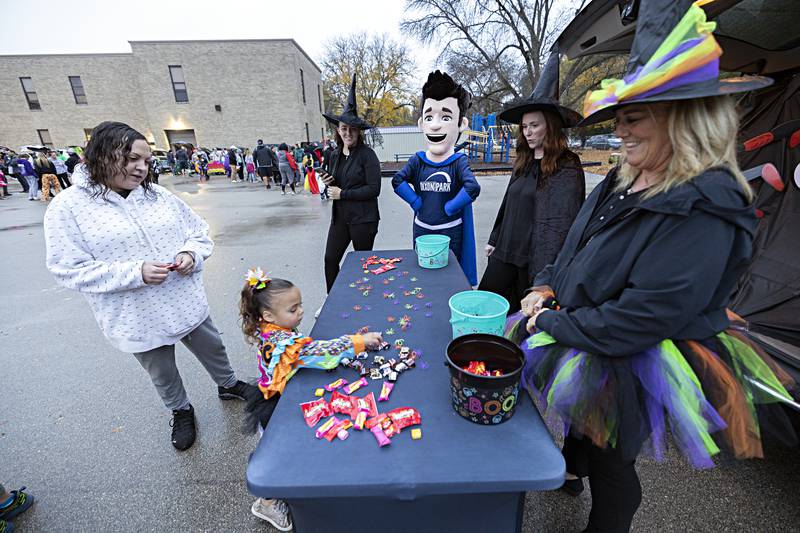 Zaleah Garcia, 4, picks a piece of candy at the Dixon Park District booth from Jana Halfacre (left) and Michelle Lawson Wednesday, Oct. 25, 2023 at Washington School.