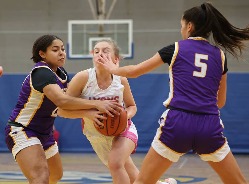 Lyons’ Avery Mezan (20) tries to get by the Downers Grove North defense during the girls varsity basketball game on Tuesday, Jan. 16, 2024 in La Grange, IL.