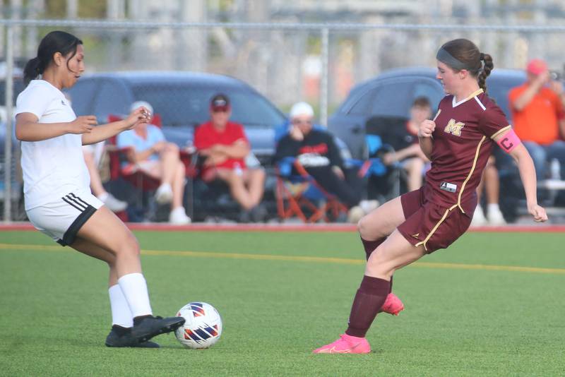 L-P's Coral Garcia kicks the ball away from Morris's Ella McDonnell during the Class 2A Regional semifinal game on Wednesday, May 15, 2024 at the L-P Athletic Complex in La Salle.