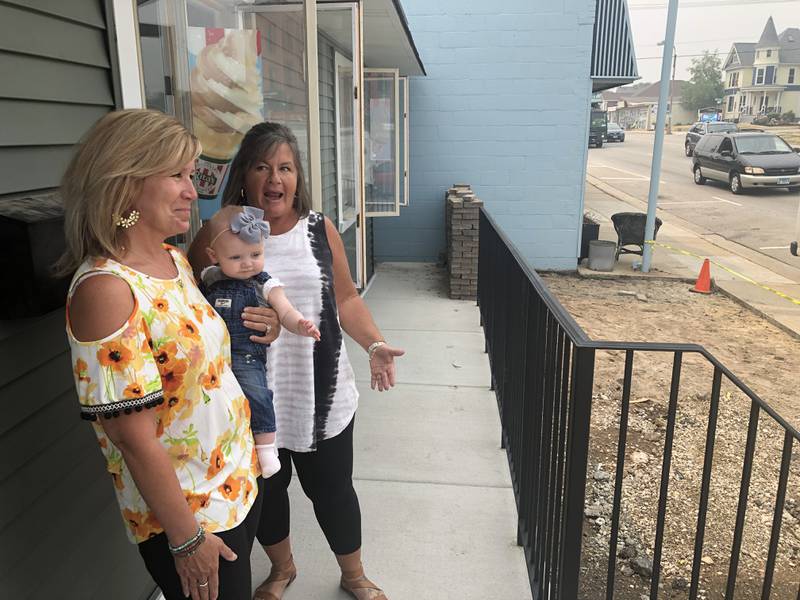 Cathy Levatino, left, holds her granddaughter, Reagan, with niece Shelly Levatino, on June 27, 2023, in downtown McHenry. Cathy is renovating the former insurance office as the new Rita's Italian Ice and Custard. which Shelly will manage.