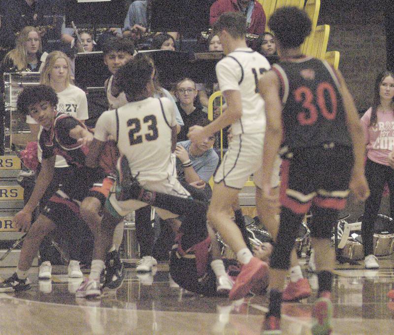 Sterling and United Township players fight for a loose ball during their game Friday, Feb. 9, 2024 at Sterling High School