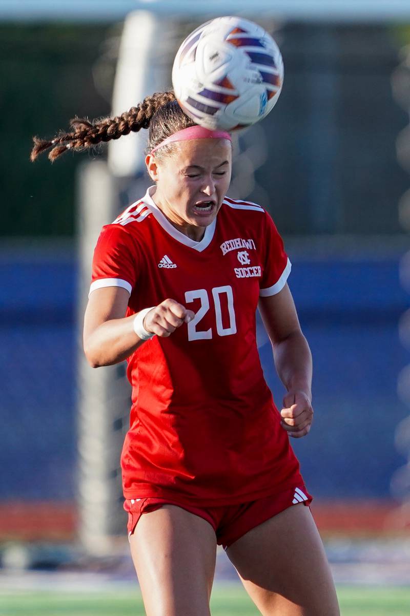 Naperville Central's Emerson Burke (20) heads the ball against St. Charles North during a Class 3A St. Charles North Supersectional soccer final match at St. Charles North High School on Tuesday, May 28, 2024.