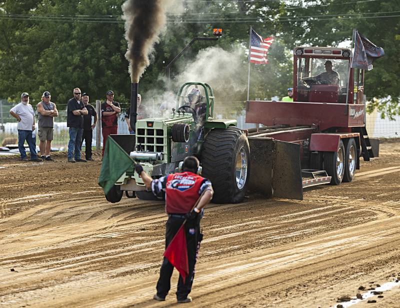 Aaron Kleckler pilots “Double Vision” to start off the Badger State Tractor Pullers event Wednesday, August 9, 2023 at the Carroll County fair.