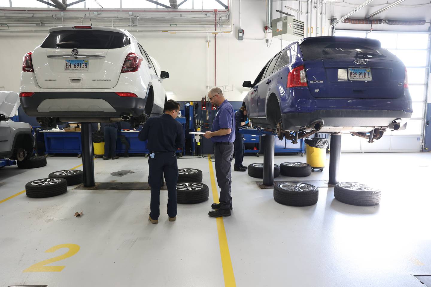 Internal Program Coordinator Andy Kacena (right) goes over Angel Loza’s work during Auto Service IV class at Joliet Junior College on Thursday, Feb. 1, 2024.