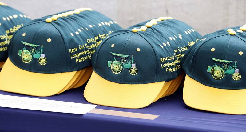 Commemorative hats are handed out during the opening of Longmeadow Parkway bridge over the Fox River Thursday, Aug. 29, 2024 in Algonquin.