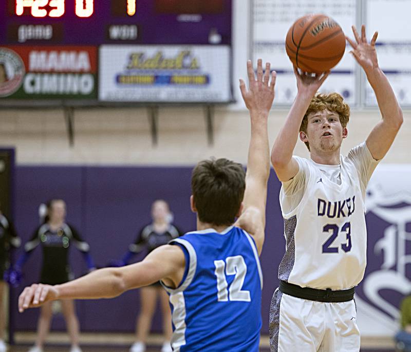 Dixon’s Austin Hicks puts up a shot against Princeton’s Tyson Phillips Thursday, Dec. 21, 2023 at Dixon High School.