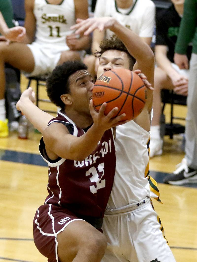 Wheaton Academy's Wandy Munoz drives to the basket against Crystal Lake South's Cooper Buelna during the IHSA Class 3A Cary-Grove Boys Basketball Regional Championship game on Friday, Feb. 23, 2024 at Cary-Grove High School.