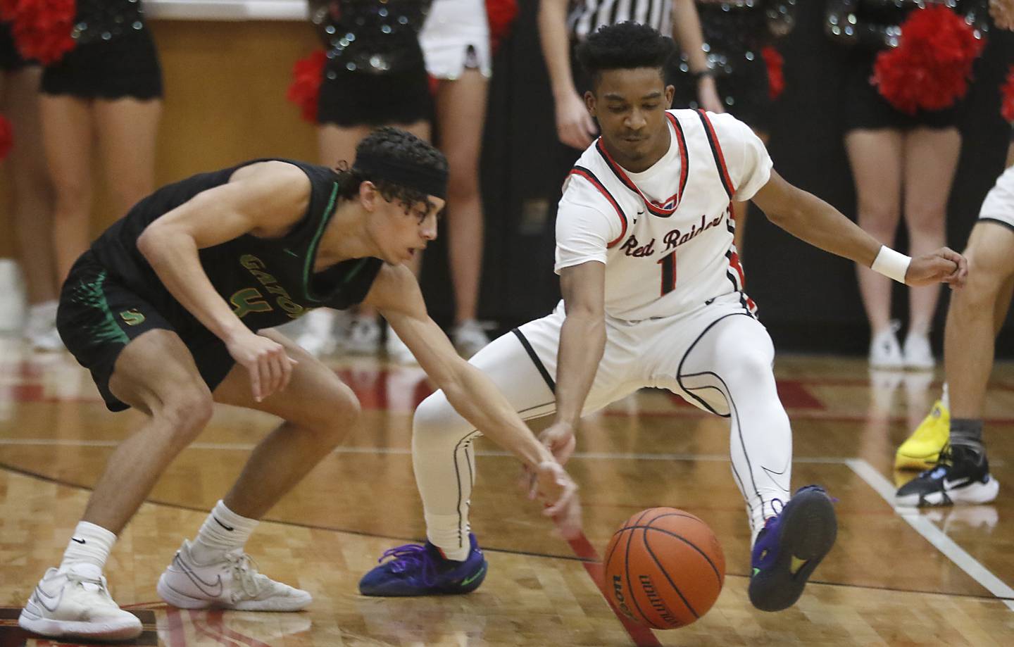 Huntley's Bryce Walker (right) chases down a loose ball in front of Crystal Lake South's AJ Demirov during a Fox Valley Conference boys basketball game Tuesday, Feb.6, 2024, at Huntley High School.