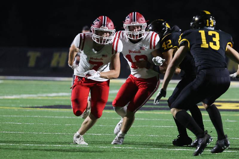 Yorkville’s Joe Freeman, left, and Luke Zook rush the punter against Joliet West on Friday, Sept. 13, 2024 in Joliet.