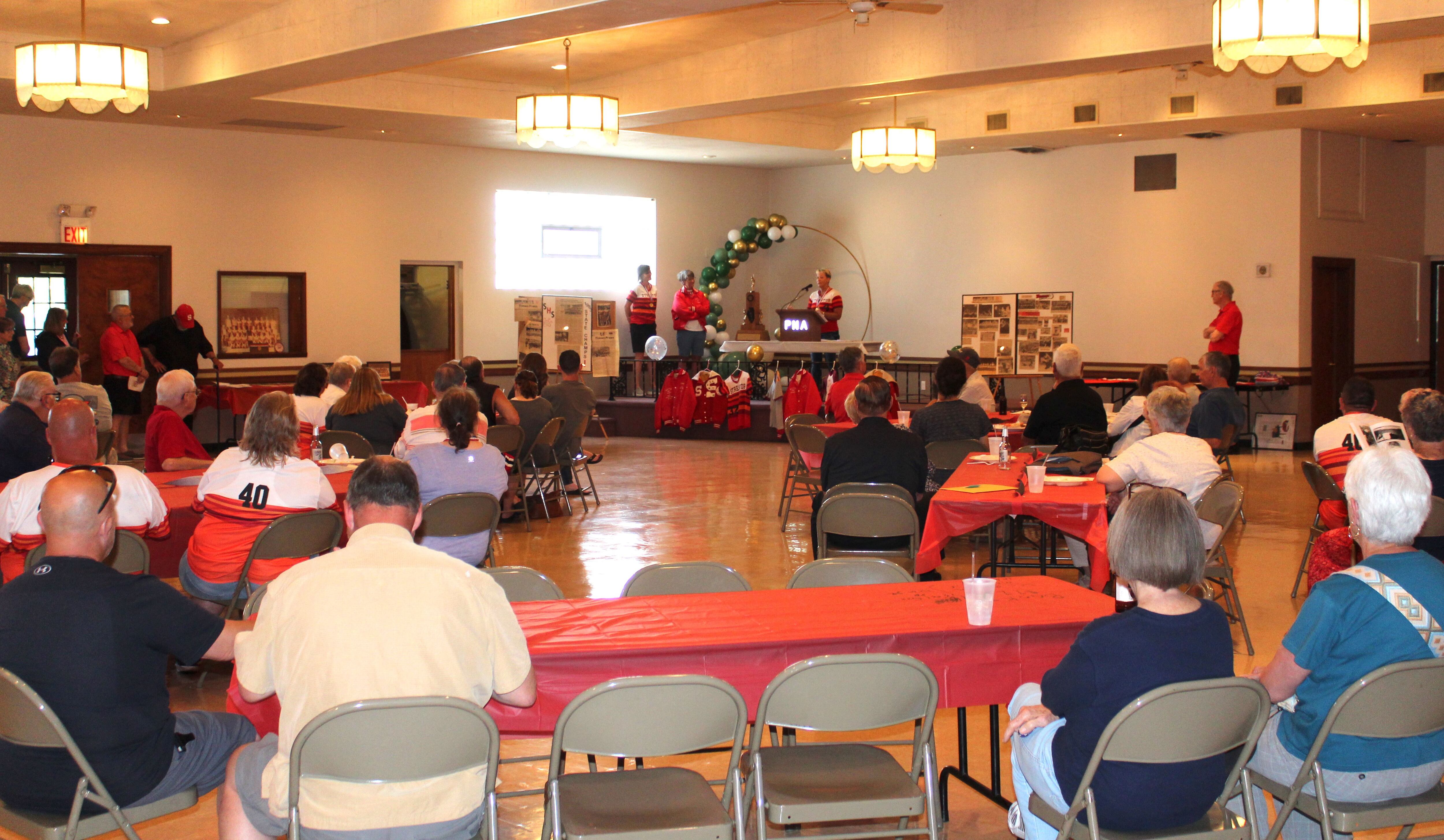 Linda Weiss speaks to the crowd during the Night of Champions event Saturday, June 10, 2023, at the Streator PNA Hall marking the 40th anniversary of the team’s state championship.