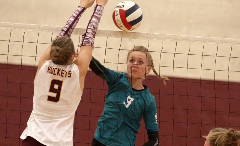 Woodstock North’s Clara Klasek, right, battles Richmond-Burton’s Reagan Winiewski at the net in varsity volleyball on Monday, Sept. 16, 2024, at Richmond-Burton High School in Richmond.