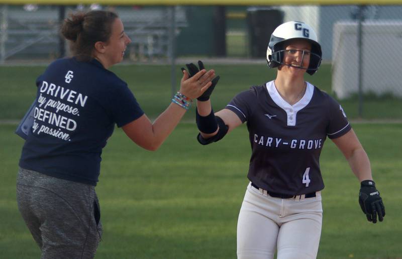 Cary-Grove’s Maddie Crick connected for a game-ending home run against Burlington Central in varsity softball at Cary Monday.