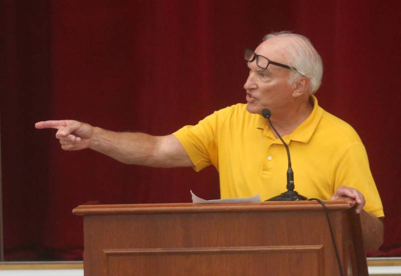 John Armstrong points to OSF officials while giving a speaks to the Illinois Health Facilities and Services Review Board during a hearing on Thursday, June 13, 2024 at Central Intermediate School in Ottawa.
