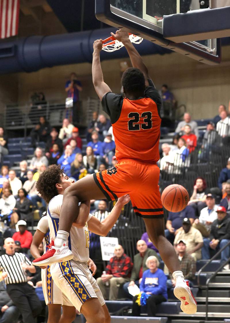 DeKalb’s Davon Grant dunks over Warren's Javerion Banks Tuesday, Feb. 27, 2024, during their Class 4A sectional semifinal game at Rock Valley College in Rockford.