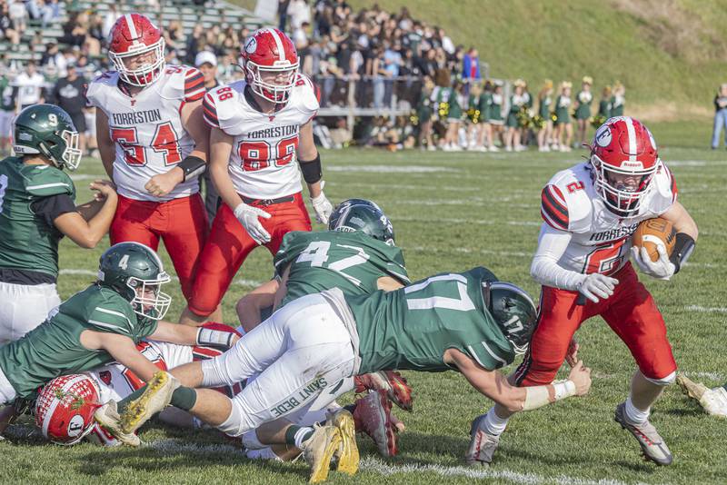 Forreston's running back Quinten Frederick (2) runs past St Bede's linebacker Nathan Lough during the Class 1A first round playoff game on Saturday, Oct. 29, 2022 at the Academy in Peru.