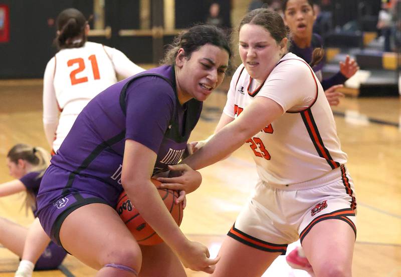 Dixon’s Hallie Williamson and Crystal Lake Central's Leah Spychala fight for a loose ball during their Class 3A sectional semifinal Tuesday, Feb. 20, 2024, at Sycamore High School.