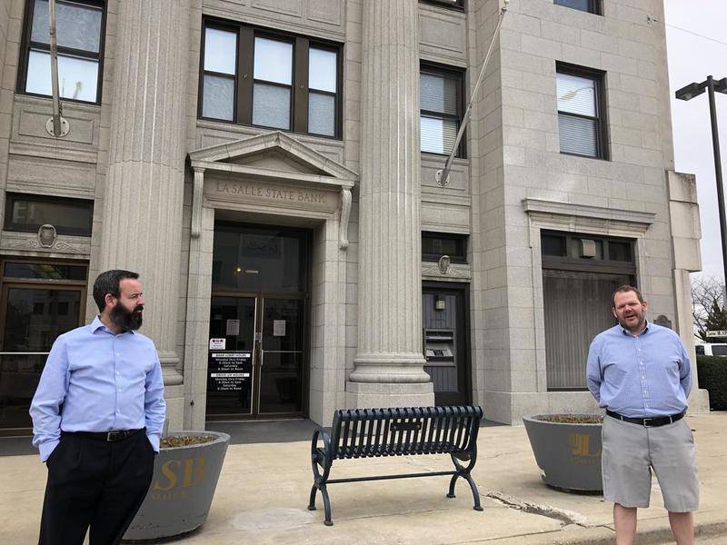 Social distancing and dressed casually, as they're generally not going to meet people face to face, La Salle State Bank senior loan officer Chris Duncan (left) and president Jeff Ellis talk about difficulties and benefits of the Paycheck Protection Program.