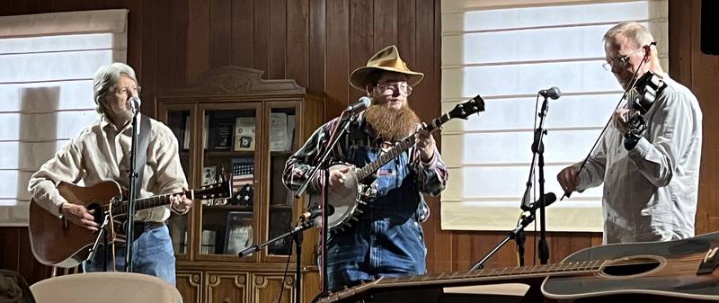 Michael Mott is a regular at First Fridays, performing traditional folk and old-time country tunes. He is accompanied in this photo by Lowell Harp on guitar and Fred Grant on fiddle.