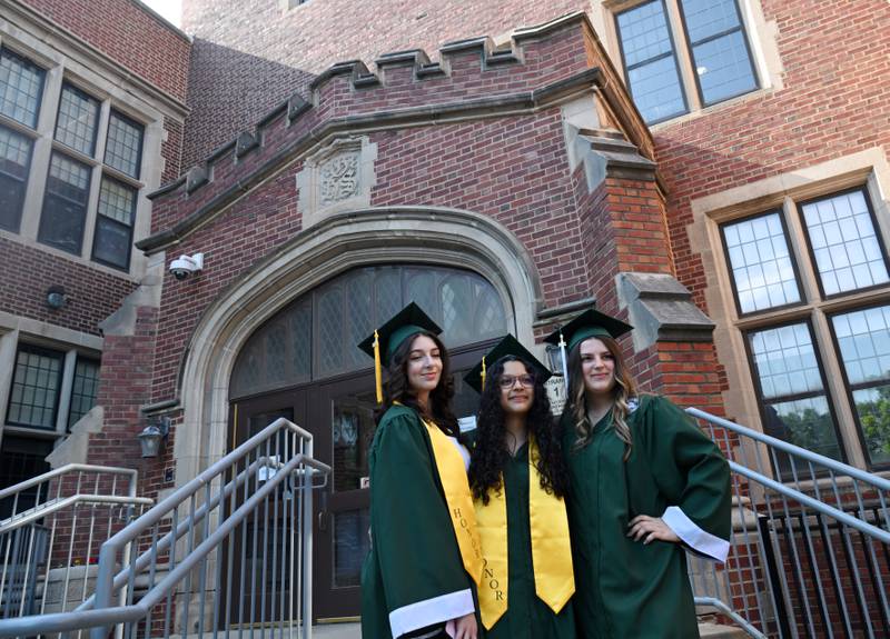 Left to right, Aya Al-tarawneh, Diana Snachez and Amelia Dabros have their photo taken in front of the school prior to the start of the Glenbard West graduation ceremony on Thursday, May 23, 2024 in Glen Ellyn.