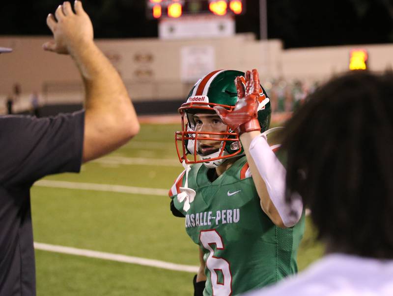 L-P's Adrian Arzola hi-fives coaches while walking off the field after making a catch against United Township on Friday, Aug. 30, 2024 at Howard Fellows Stadium.