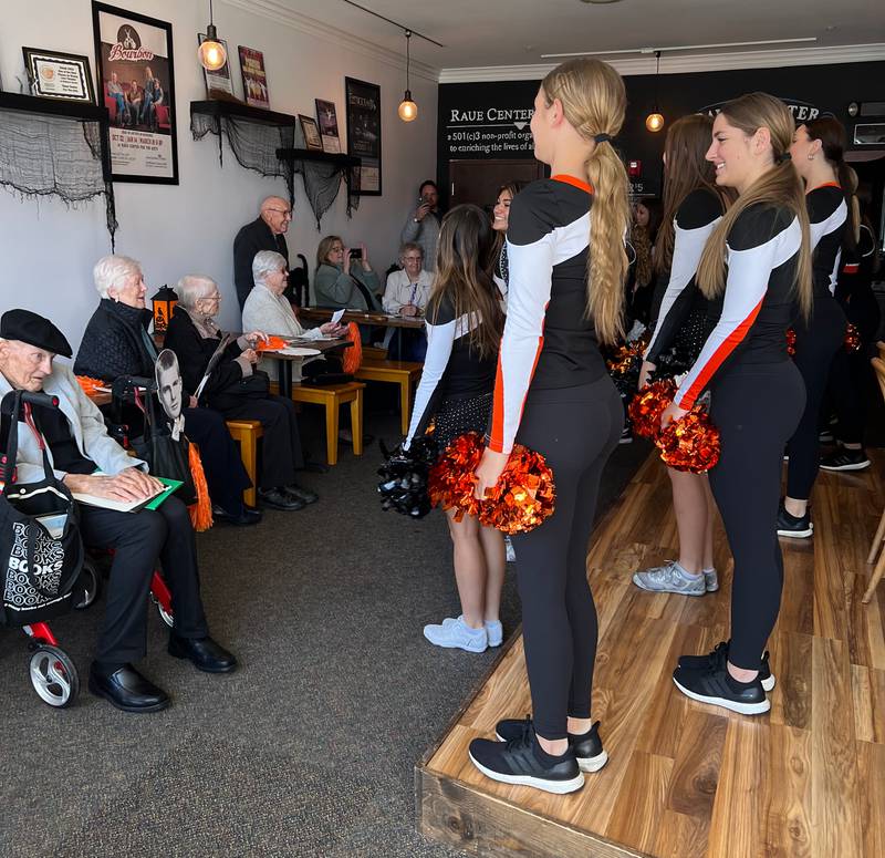 The Crystal Lake Central High School Class of 1952 watches current Crystal Lake Central cheerleaders perform the school song at the class's 70th reunion on Saturday, Oct. 8, 2022.