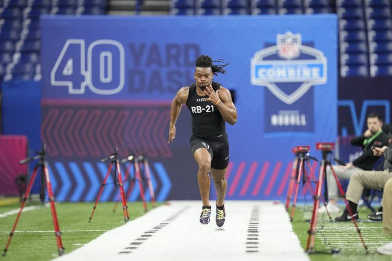 Texas running back Bijan Robinson runs a drill at the NFL scouting combine in Indianapolis, Sunday, March 5, 2023.