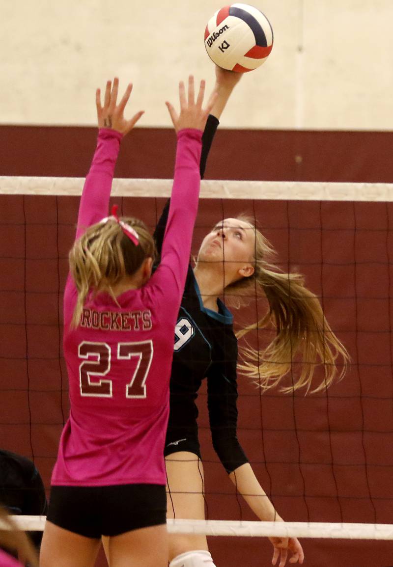 Woodstock North’s Clara Klasek tries to hit the ball past Richmond-Burton's Dani Hopp during a Kishwaukee River Conference volleyball match Wednesday, Oct.11, 2023, at Richmond-Burton Community High School.