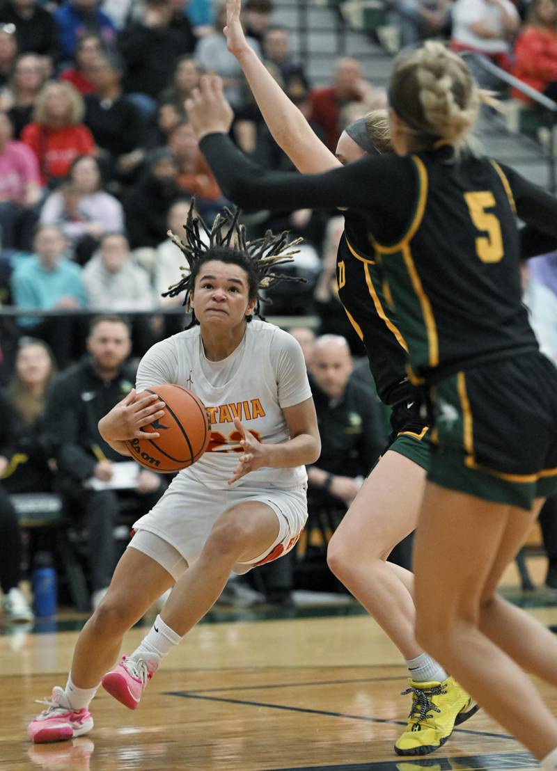 Batavia’s Addison Prewitt drives under the Fremd defense in the Bartlett supersectional game on Monday, Feb. 26, 2024.