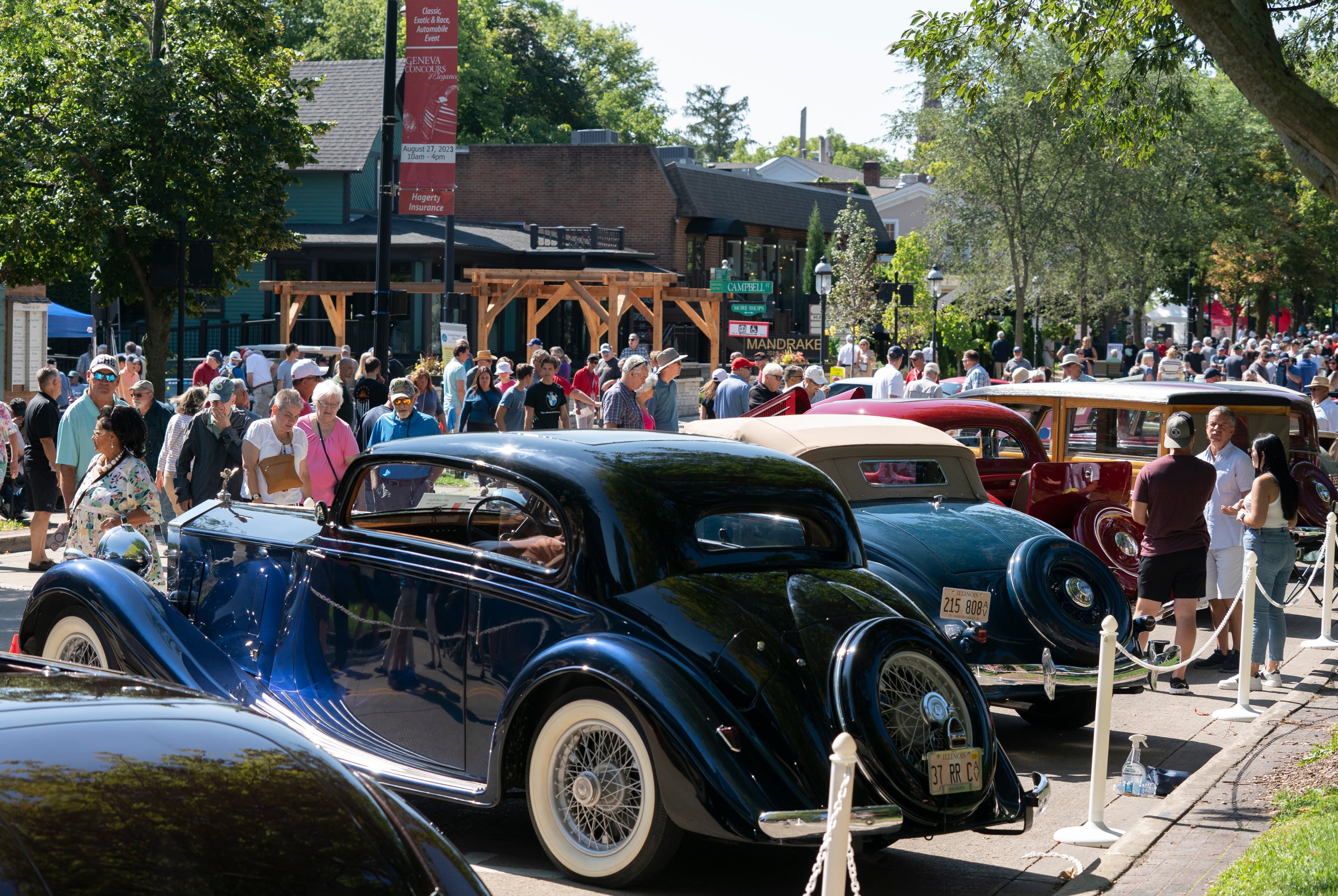 Crowds gather along Third Street in downtown Geneva during the 2023 Concours d'Elegance car show on Sunday, August 27, 2023. Car enthusiasts and spectators gathered for the free show that featured antique, classic and modern automoblies on display.