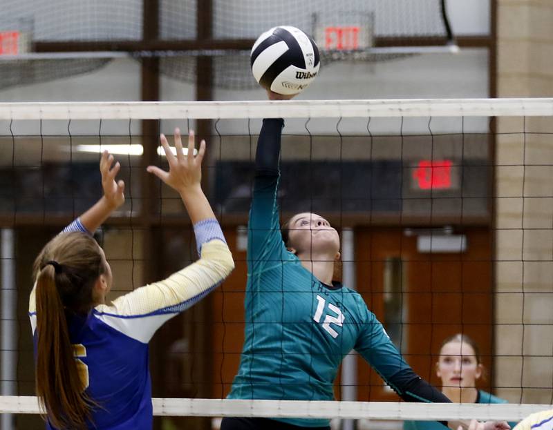 Woodstock North's Gabriella Schefke hits the ball away from Johnsburg's Kimmy Whitlock during a Kishwaukee River Conference volleyball match on Wednesday, Sept. 4, 2024, at Woodstock North High School.