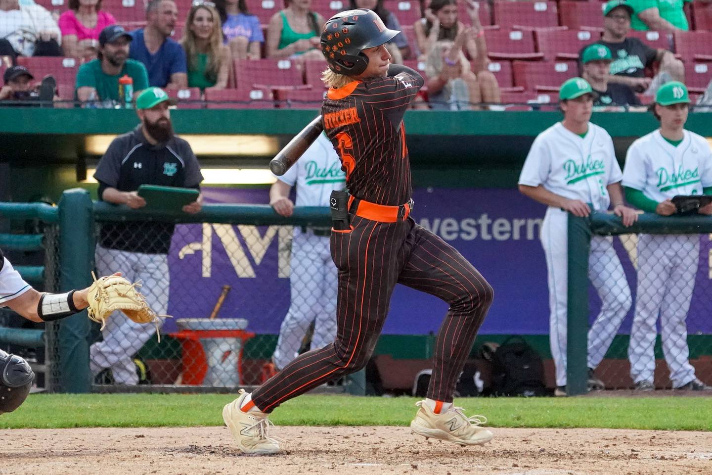 McHenry's John Stecker (6) singles against York during a class 4A Kane County supersectional baseball game at Northwestern Medicine Field in Geneva on Monday, June 3, 2024.