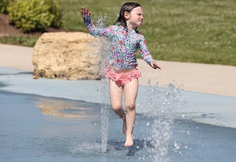 Scarlett Thunder, 4, from Sycamore, runs through the sprinklers Tuesday, June 14, 2022, at at the Sycamore Park District’s Splash Fountain. Temperatures reached nearly 100 degrees Tuesday and highs are expected to remain in the 90's through Thursday.