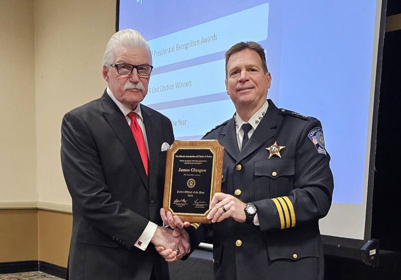 President of the Illinois Association of Chiefs of Police, Chief Marc Maton (right) presents Will County State’s Attorney James Glasgow with the ILACP Public Official of the Year Award during the ILACP executive board meeting at the Midwest Security & Police Conference/Expo in Tinley Park, Illinois on Aug. 22, 2024.