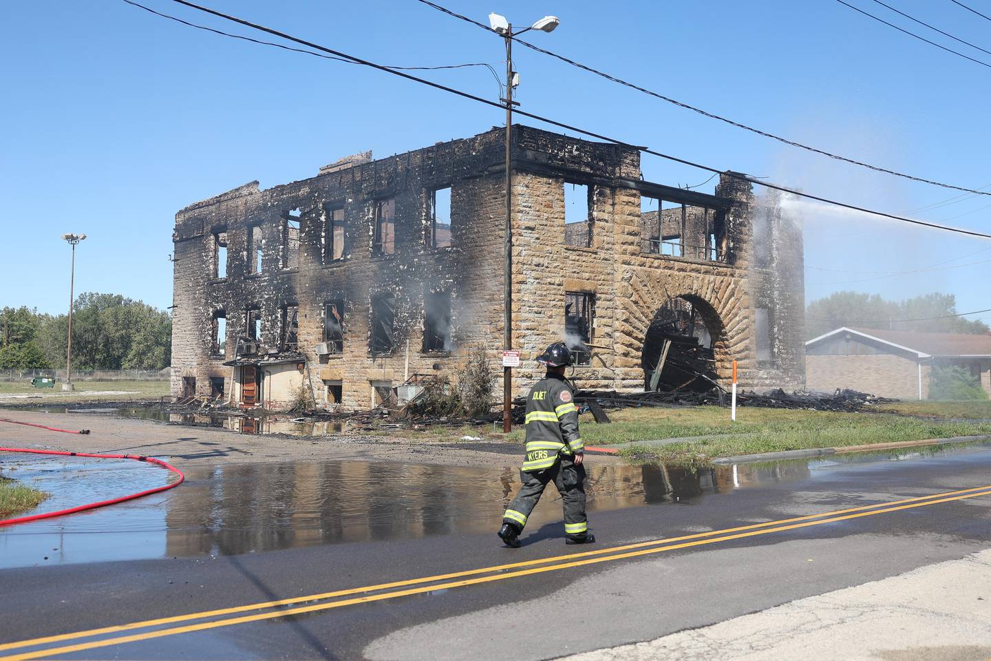 Joliet Fire Department continues to work the scene at the historic U.S. Steel office building on Saturday, Sept. 7, 2024 in Joliet. The historic building along Collins Street was engulfed in flames early Saturday.