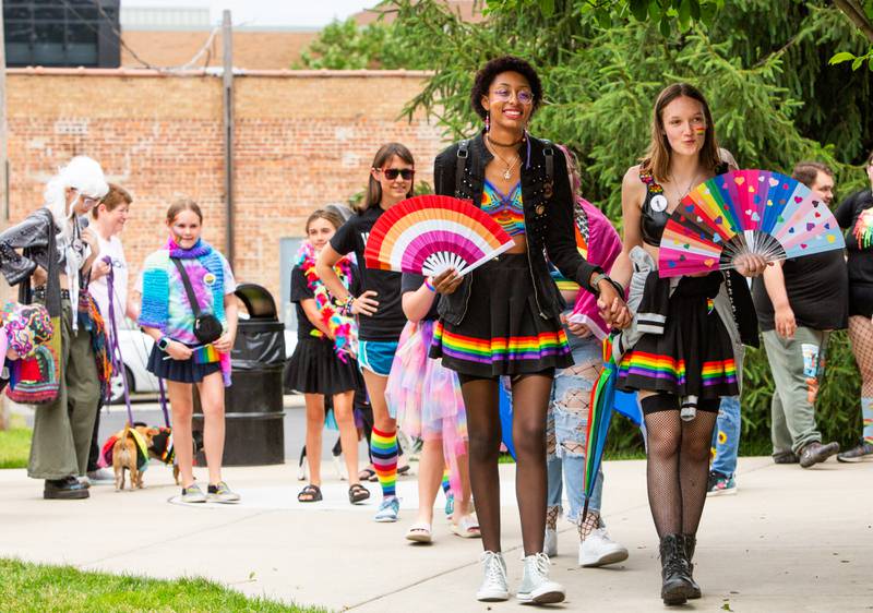 Briana Parish (left) and Hannah Brown take their turn to walk across the stage during the dog and human parade at the Downer’s Grove Pride Fest on Saturday, June 8, 2024.

Suzanne Tennant/For Shaw Local News Media