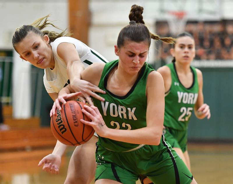 York's Stella Kohl tries to protect the ball as Glenbard West's Scarlett Schultz reaches for it during a game on Jan. 22, 2024 at Glenbard West High School in Glen Ellyn.